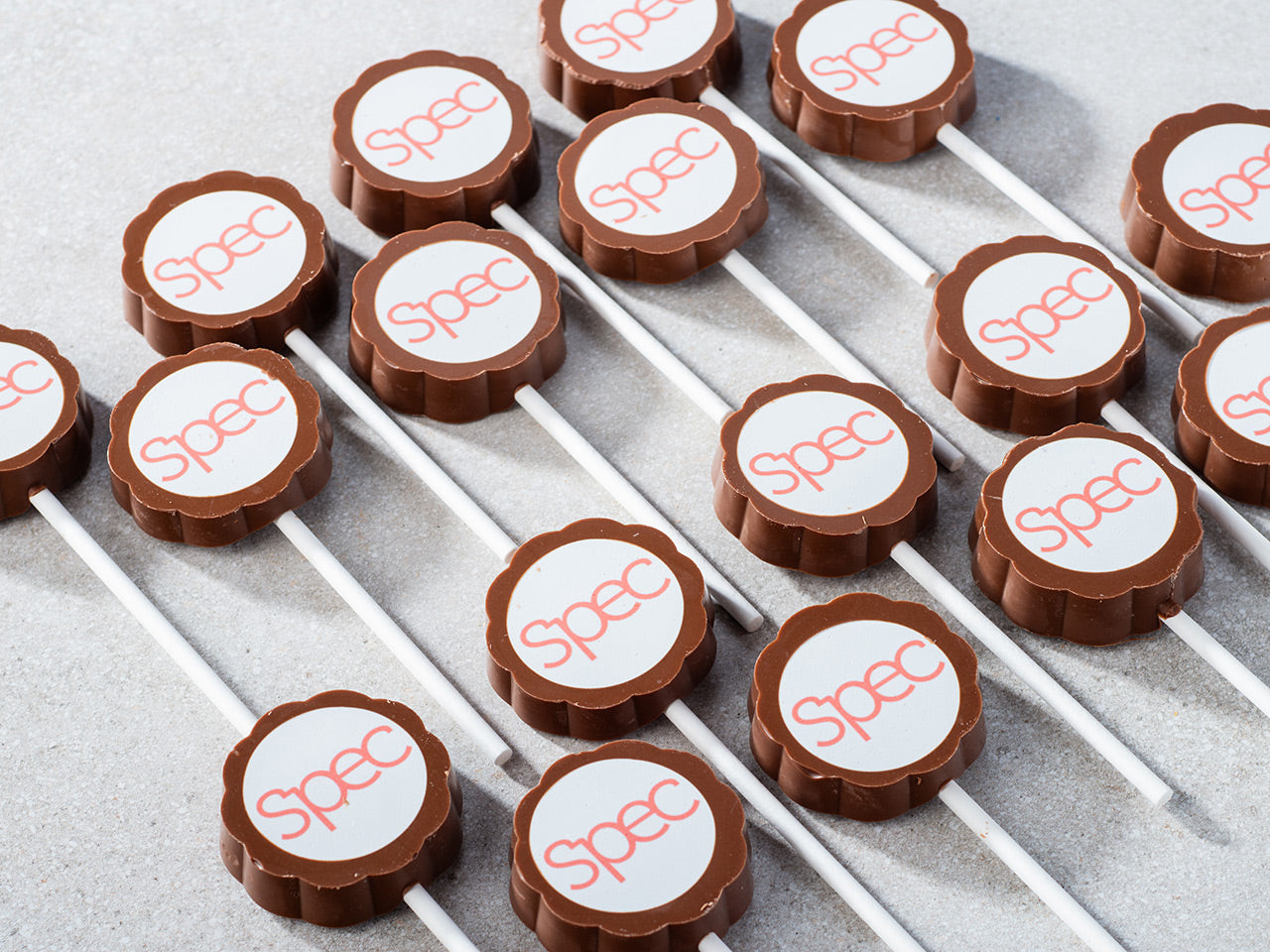 Chocolate lollypops with a brand logo