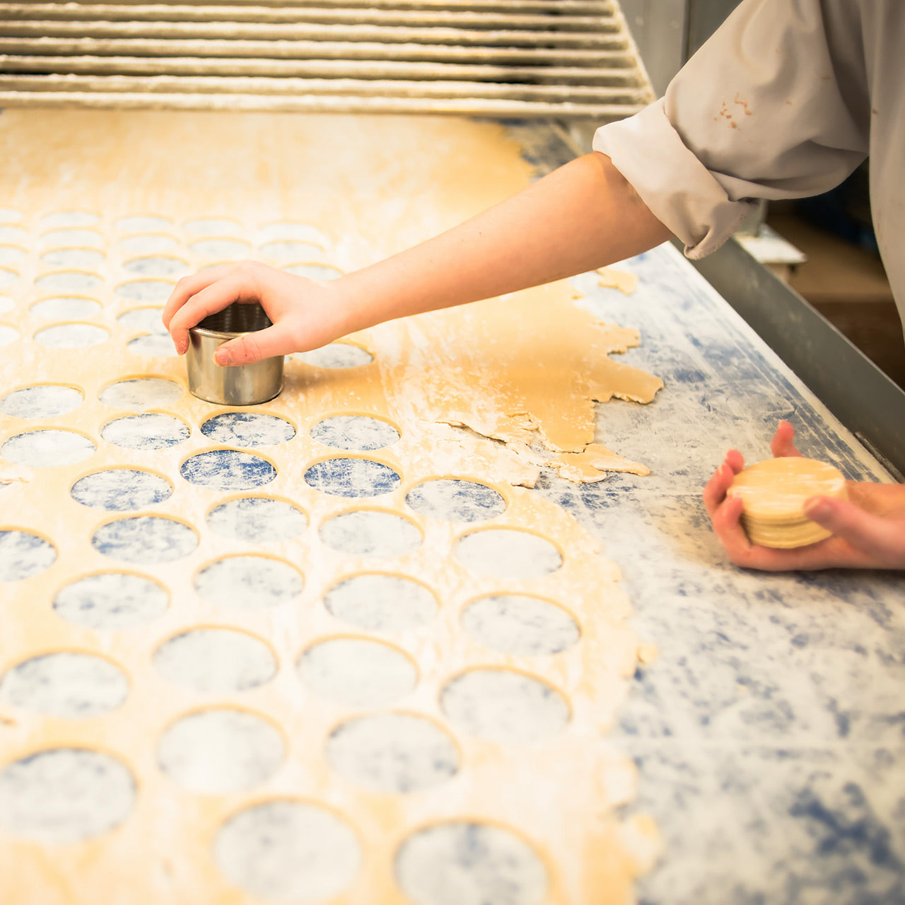 Pastry being cut with a round cookie cutter