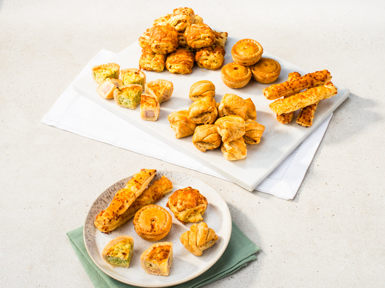Small savoury platter including quiche, sausage roll bites and pork pies